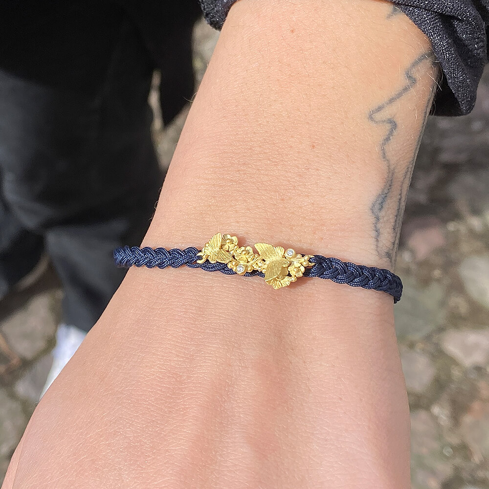 lene-vibe_B-086_18k-yellow-gold-flowers-and-butterflies-tahitian-pearl-braided-navy-nylon-cord-bracelet_model