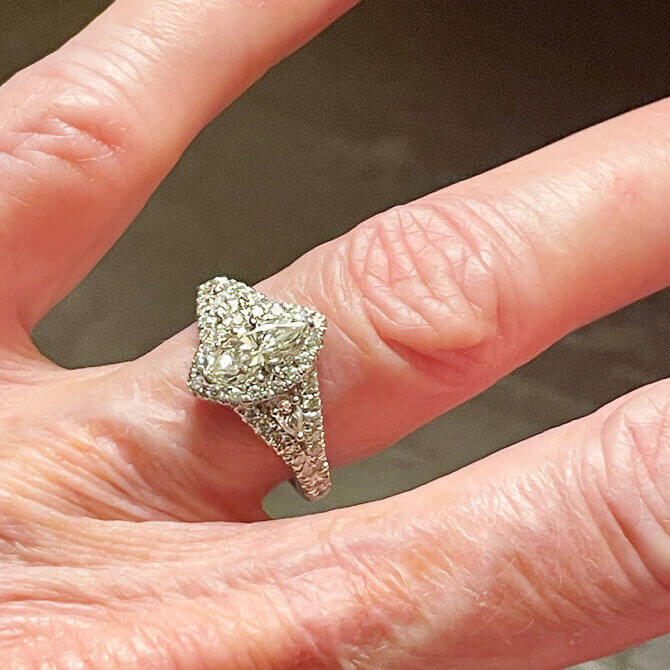 A treasured marquise diamond transformed into a modern platinum engagement ring with a sparkling diamond halo.