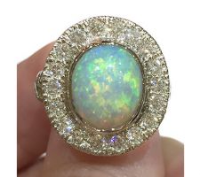 Custom engagement ring with client opal and diamonds set in 14k white gold.