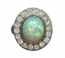Custom engagement ring with client opal and diamonds set in 14k white gold.
