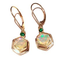 Ethiopian Opal from our Gemstone Round Table with Tsavorite garnets bezel set in 14K yellow gold.