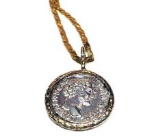 Dyanne Belle designed this pendant with a client’s ancient Greek coin. The coin is set in 14k yellow gold.