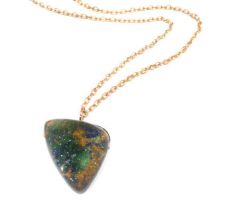 Idocrase Druzy from our Gemstone Roundtable set as a pendant on a yellow silver chain.