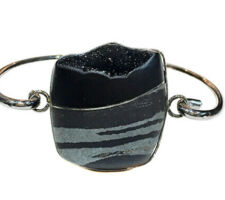 Steve Walter’s gem was purchased at our Gemstone Roundtable and was set into rhodium plated sterling silver by Dyanne Belle. It can be worn as a bracelet or necklace.