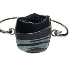 Steve Walter’s gem was purchased at our Gemstone Roundtable and was set into rhodium plated sterling silver by Dyanne Belle. It can be worn as a bracelet or necklace.