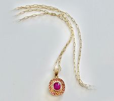 Purchased sapphire at our Gemstone Roundtable. Pink Sapphire is surrounded by a halo of orange sapphires and set in 14K yellow gold.