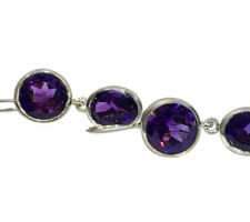 These earrings, set in sterling silver, were designed by Dyanne Belle with a client’s amethyst stones.