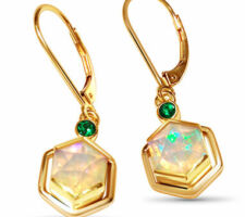 Ethiopian Opal from our Gemstone Round Table with Tsavorite garnets bezel set in 14K yellow gold.