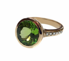 The peridot in this ring was purchased at our Gemstone Roundtable and was set in 14k gold with pave peridot down the shank by Dyanne Belle.