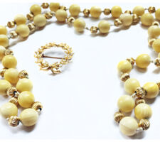 Ivory bead necklace and pearl brooch before repurposing.